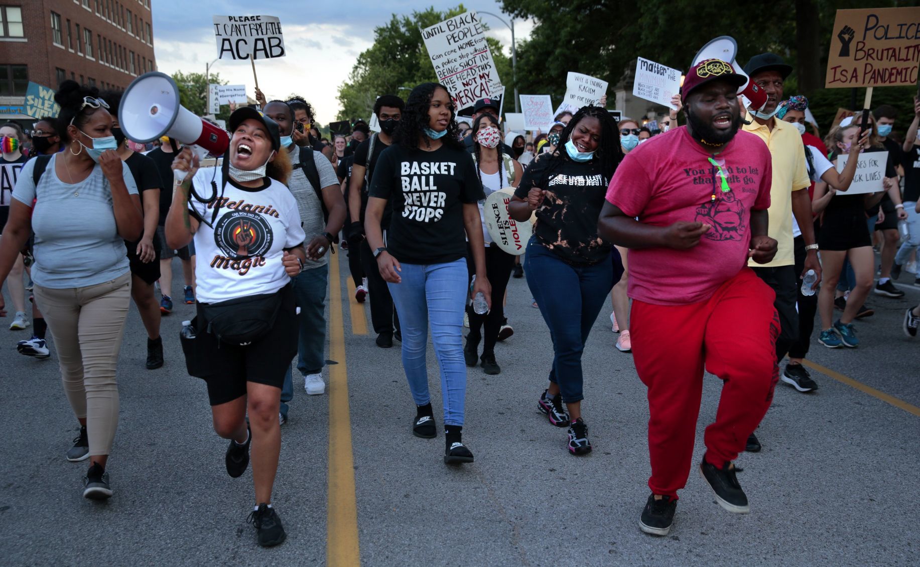 Protesters march through the Delmar Loop